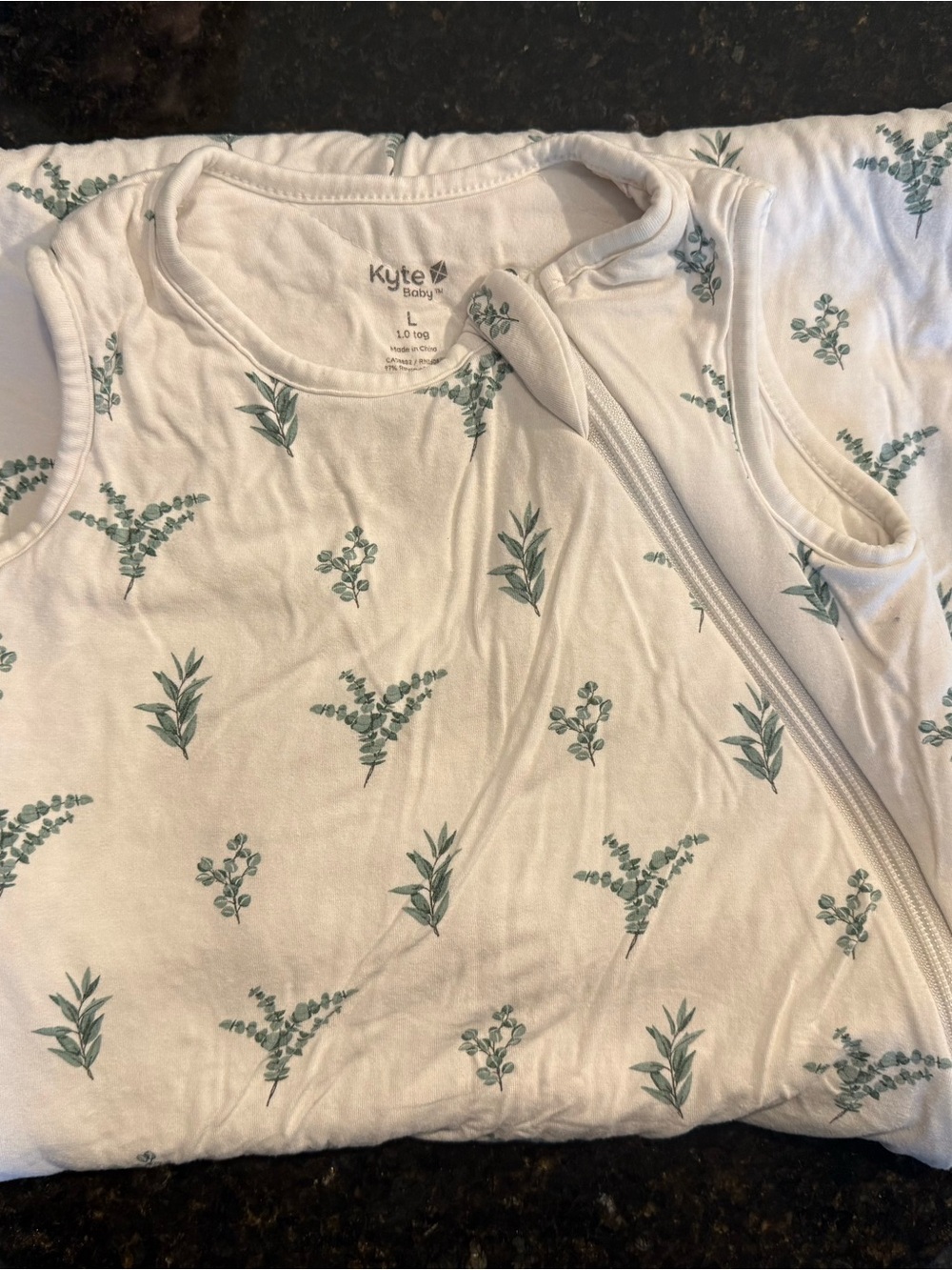 Kyte BABY White Sleeveless Zip Romper with Green Botanical Print